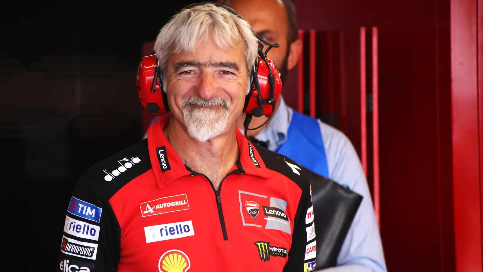 Джиджи Дал’Иня с екипа на Ducati Corse по време на Гран при на Унгария на Балатон през август 2025 г. — архивен кадър, не от Мотеги 2026. René 2782 / Wikimedia Commons, CC BY-SA 4.0; оригинал: https://commons.wikimedia.org/wiki/File:Gigi_Dall%27Igna_GP_Ungheria,_Balaton_(2025).jpg ; лиценз: https://creativecommons.org/licenses/by-sa/4.0/ ; пропорционално изрязана и преоразмерена до 16:9, производното изображение е под CC BY-SA 4.0.